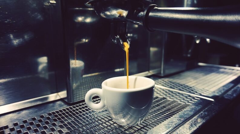An espresso machine making a cup of coffee.