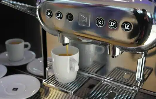 a cup of machine-made coffee being made