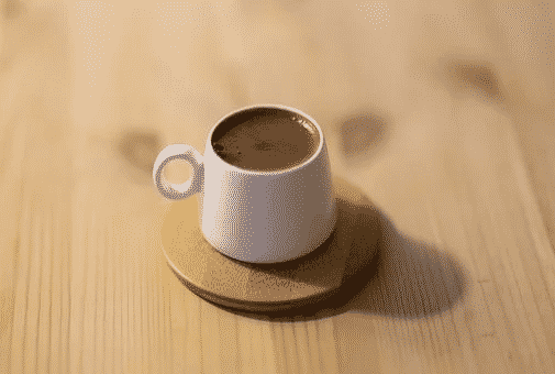 A white cup filled with turkish coffee