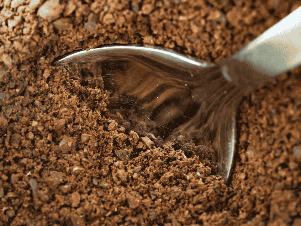 Ground coffee in a spoon